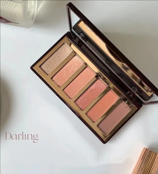 Open palette showing six eyeshadow shades arranged in a rectangular case