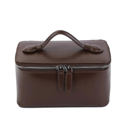 Front view of leather makeup bag showing handheld design and closure