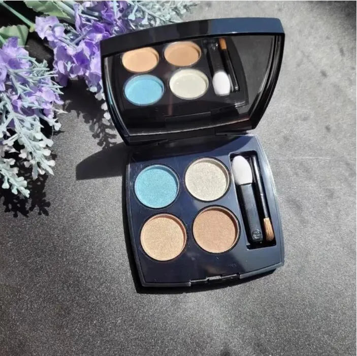 Four-color eyeshadow palette open with glitter and matte shades