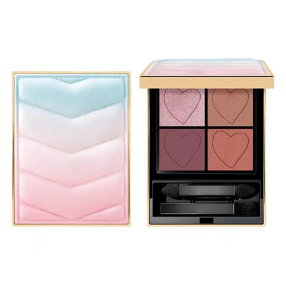 Compact eyeshadow palette open showing matte shades and included brush