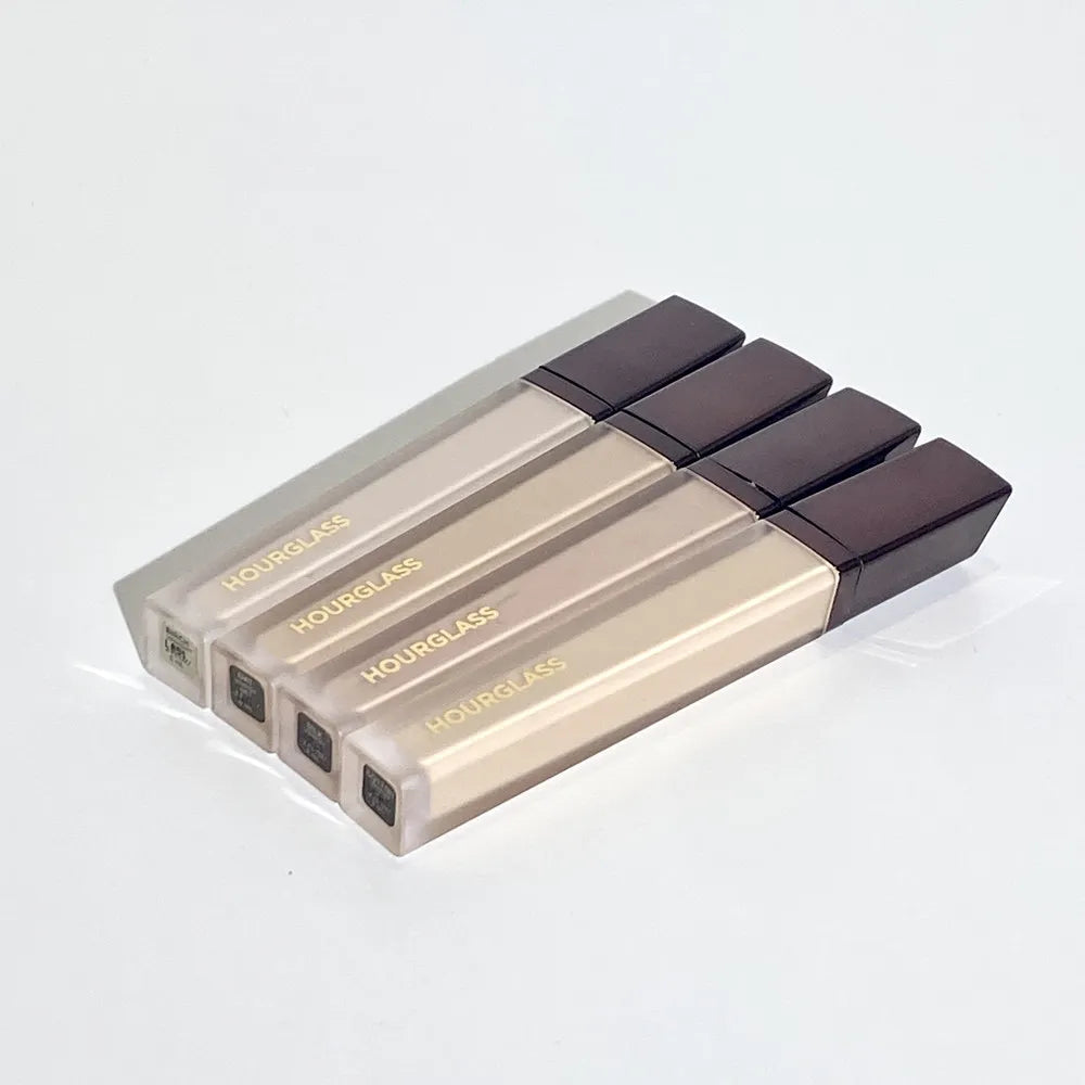 Liquid concealer stick in neutral packaging with applicator tip visible