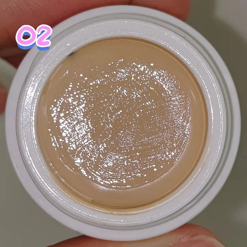 Close-up view of creamy concealer texture being swatched on skin