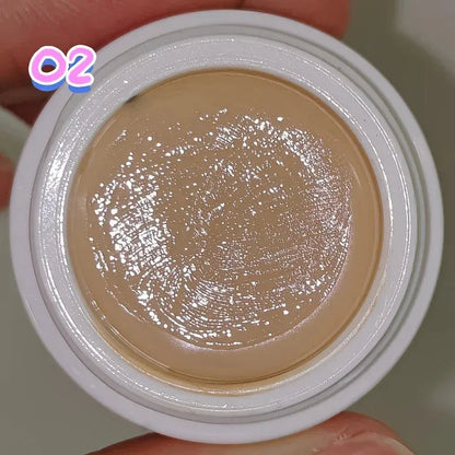 Close-up view of creamy concealer texture being swatched on skin