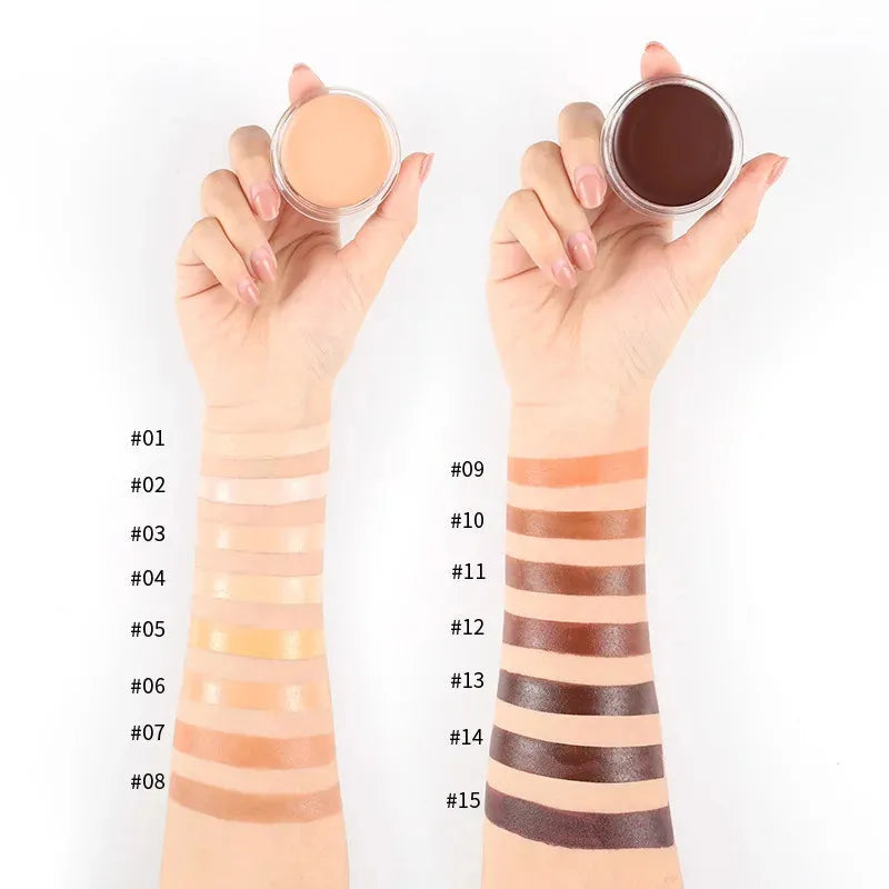 Open makeup palette showing multiple shades of concealer arranged in rectangular pans