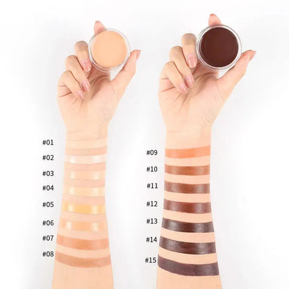 Open makeup palette showing multiple shades of concealer arranged in rectangular pans
