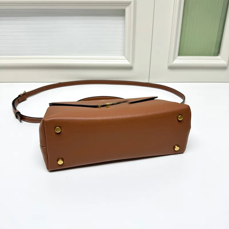 Front view of leather crossbody bag showing baguette shape and strap