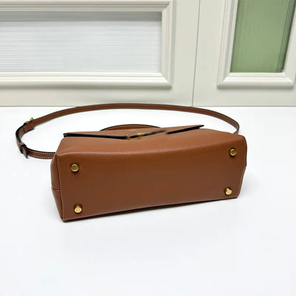 Front view of leather crossbody bag showing baguette shape and strap