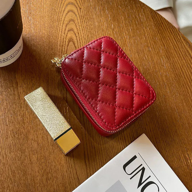 Leather cosmetic case displayed next to lipstick tubes for size comparison