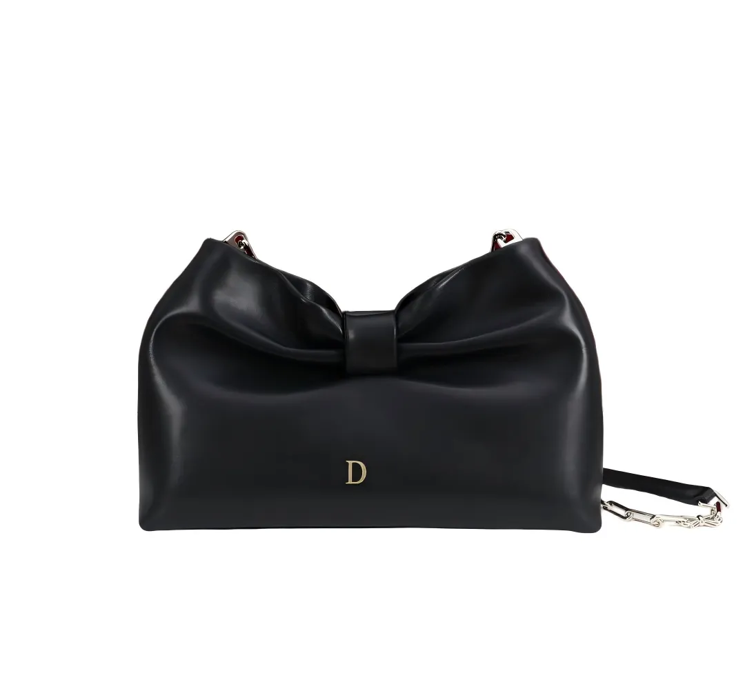 Front view of women's clutch bag with bow design in dark grey color
