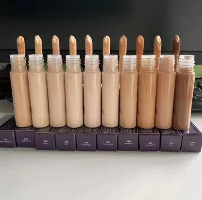 Concealer product displayed with applicator on neutral background
