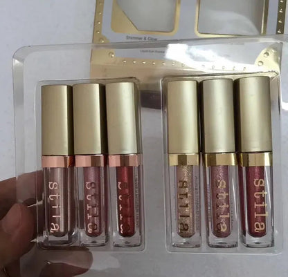 Six liquid eyeshadow shades in earth tones displayed in packaging