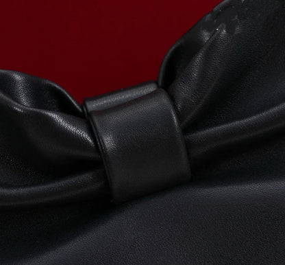 Side angle showing structured form and tote handles of evening bag