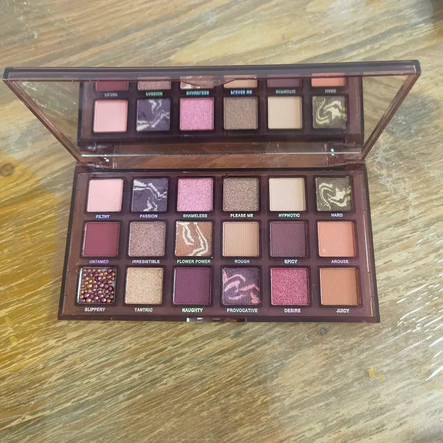 Eyeshadow palette with brush displayed at angle