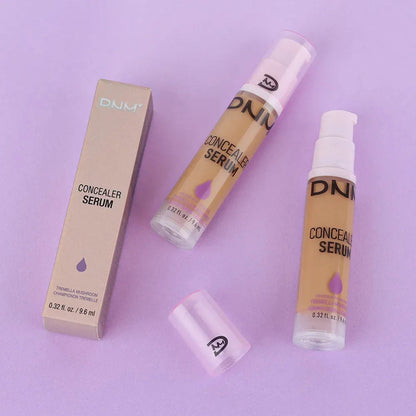 Liquid concealer bottle with applicator displayed on neutral background