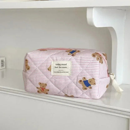 Cosmetic bag in various color options displayed on a flat surface