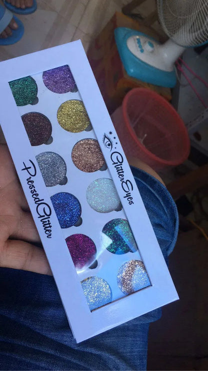 Open 12-color glitter eyeshadow palette showing shimmer shades