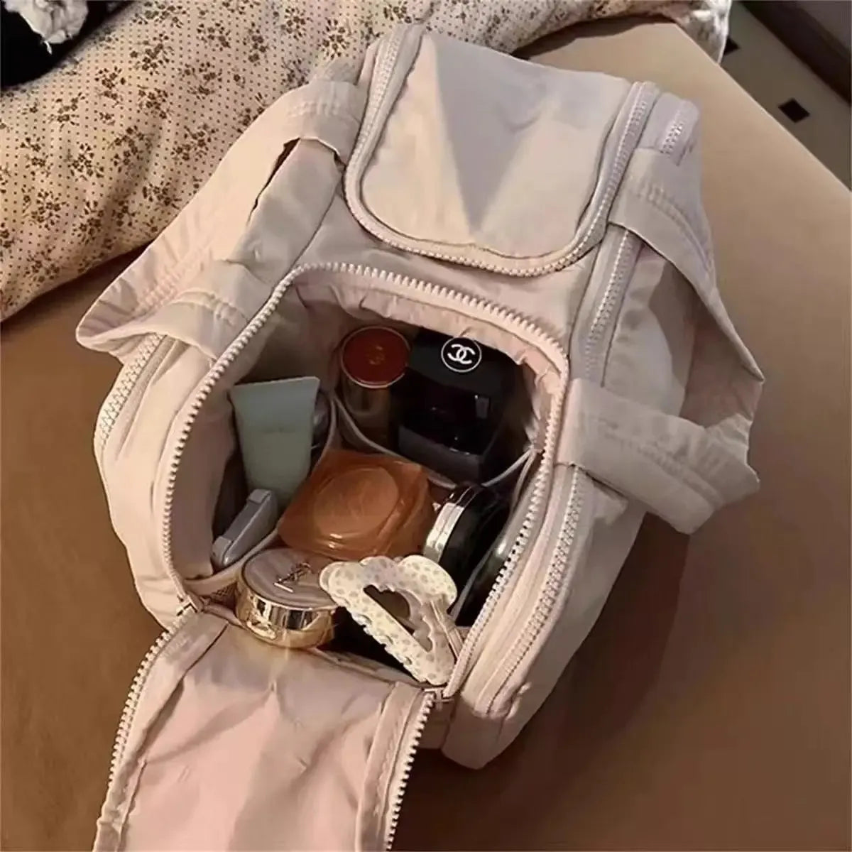 Front view of a portable makeup bag with four openings
