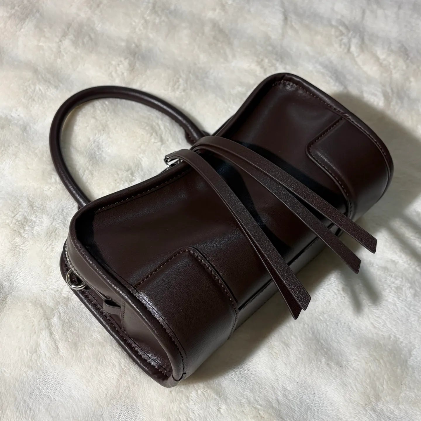 Front view of a luxury shoulder tote bag showing design and strap