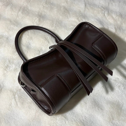 Front view of a luxury shoulder tote bag showing design and strap