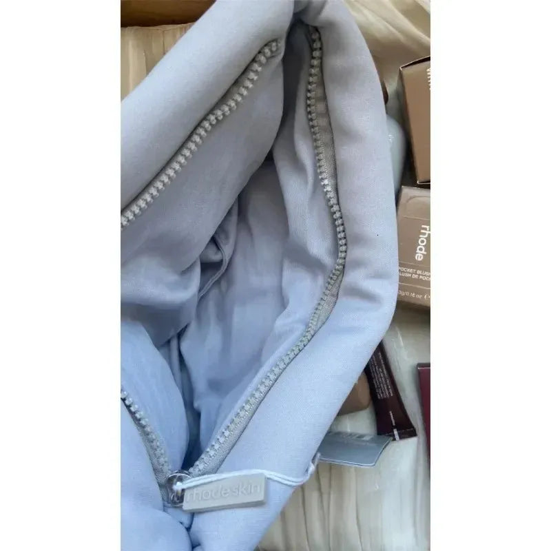 Side profile displaying compact design and zipper closure