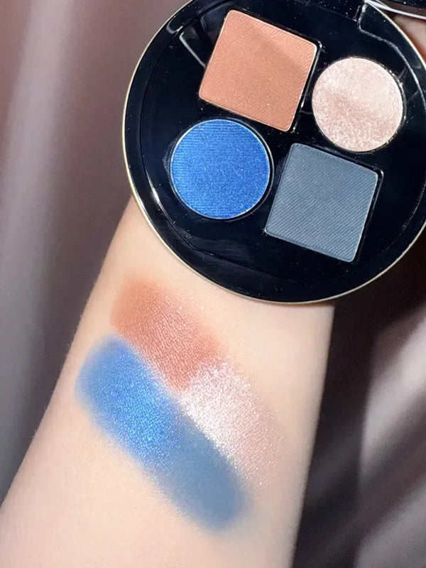 Eyeshadow palette open displaying marine, fume, and mordre color options