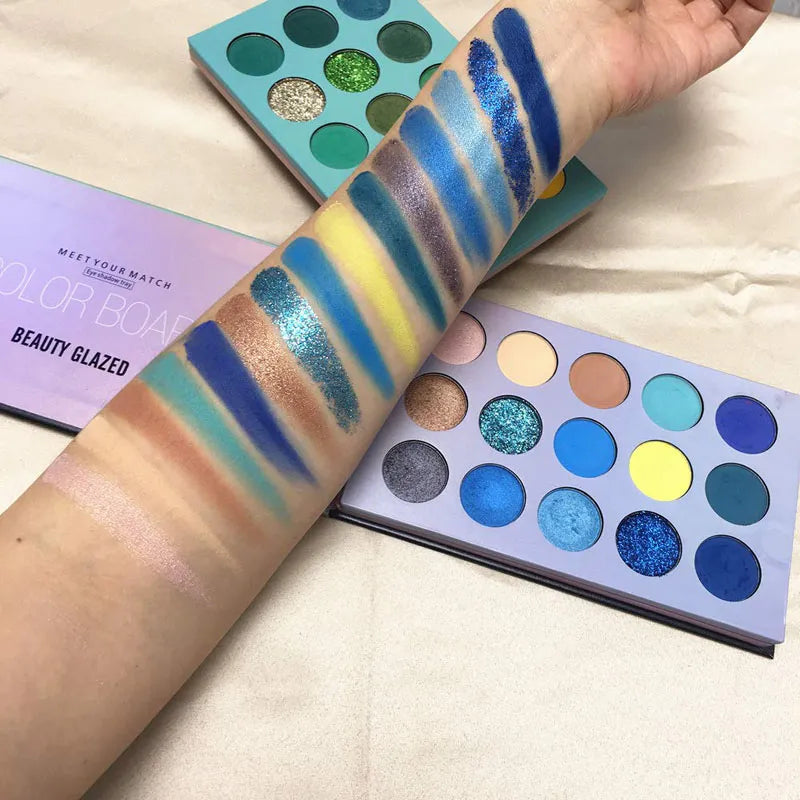 Eyeshadow palette with applicator tool on cosmetic background