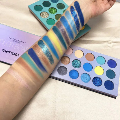 Eyeshadow palette with applicator tool on cosmetic background