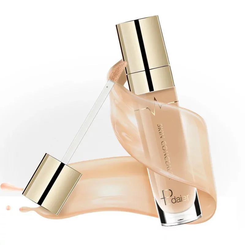 Liquid concealer bottle with doe-foot applicator on clean surface