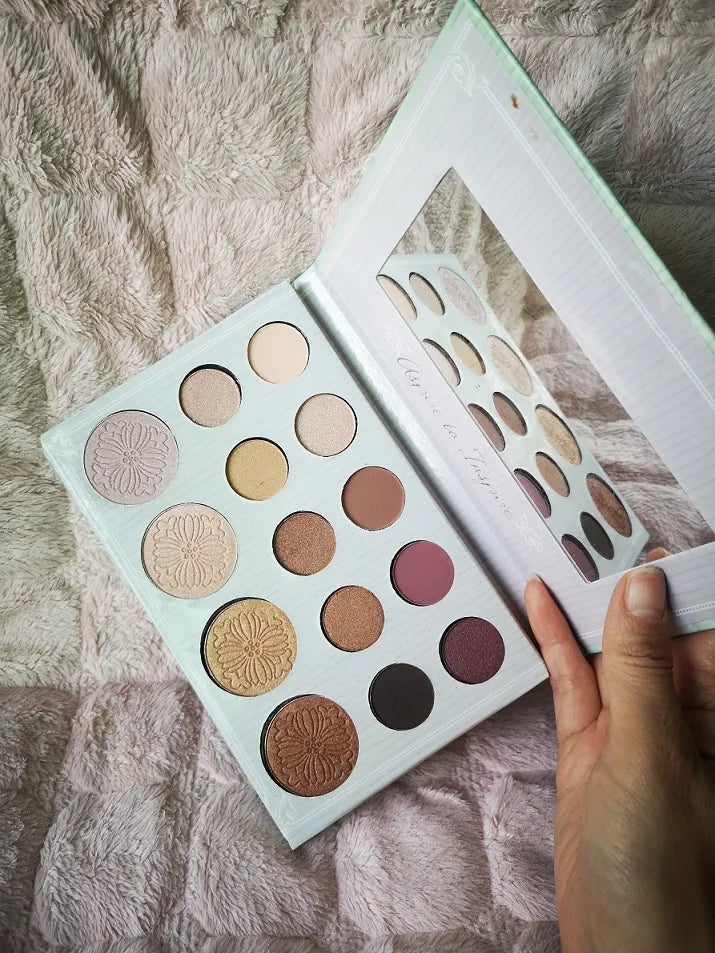 14-color eyeshadow and highlighter palette with open lid showing shades