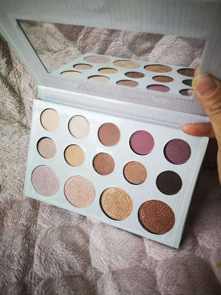 14-color eyeshadow and highlighter palette with open lid showing shades