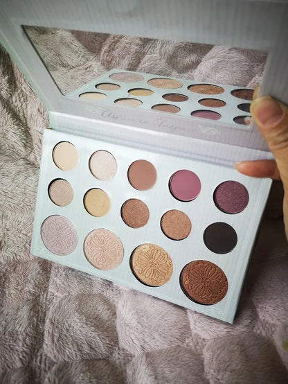 14-color eyeshadow and highlighter palette with open lid showing shades