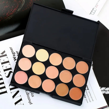 Complete concealer set with palette and brush displayed on neutral background