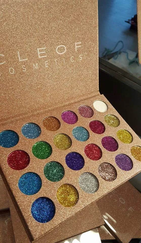 Open eyeshadow palette showing 24 glitter shades in organized layout