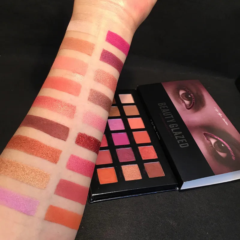 Open eyeshadow palette displaying matte and shimmer finishes in a compact design