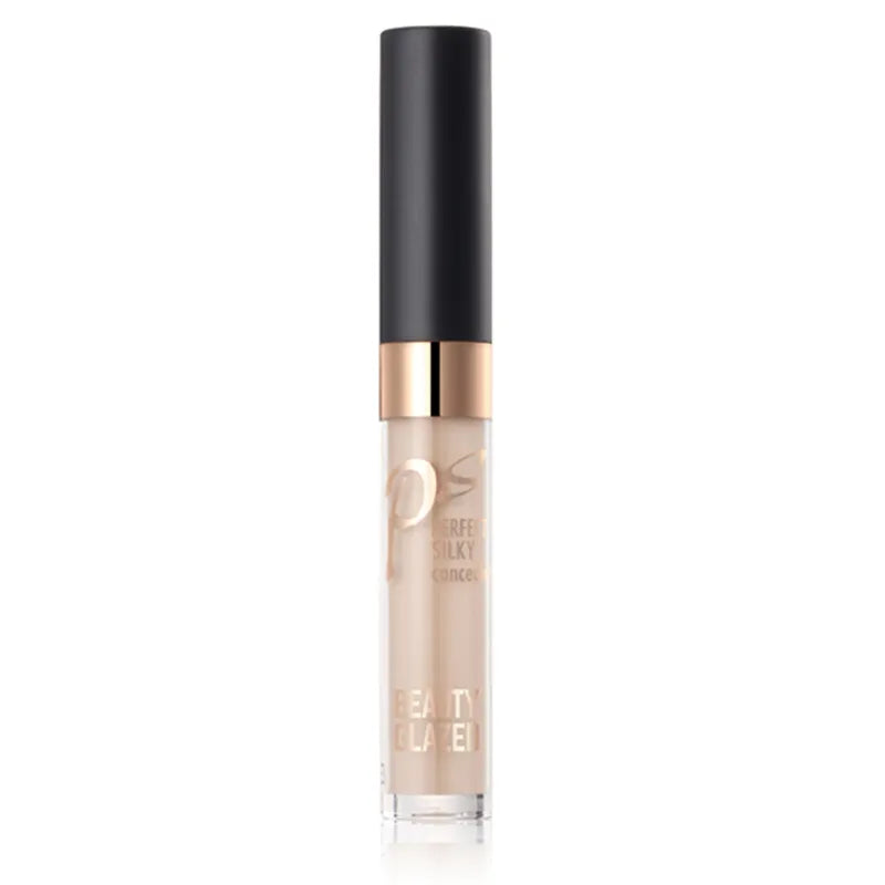 Close-up view of cream concealer texture with makeup brush nearby