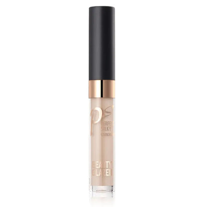 Close-up view of cream concealer texture with makeup brush nearby