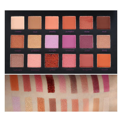 Open eyeshadow palette displaying matte and shimmer finishes in a compact design