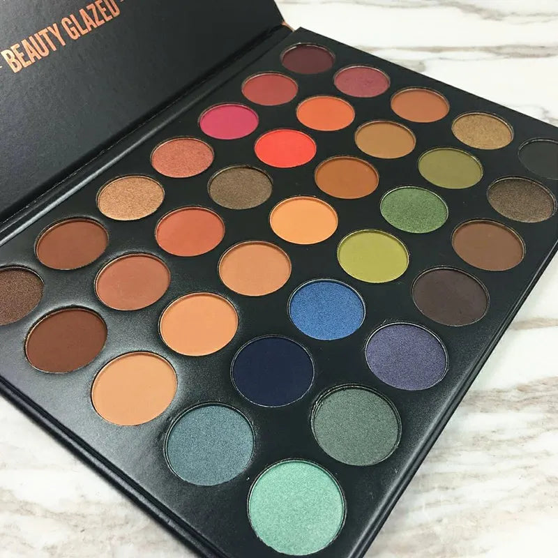 Eyeshadow palette in use with brush application on eyelid