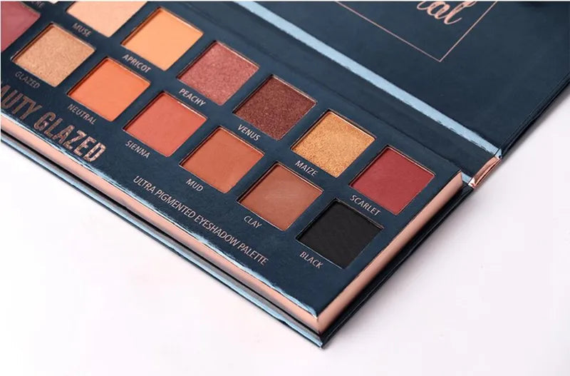 Matte eyeshadow palette with glitter shades in warm colors, open view