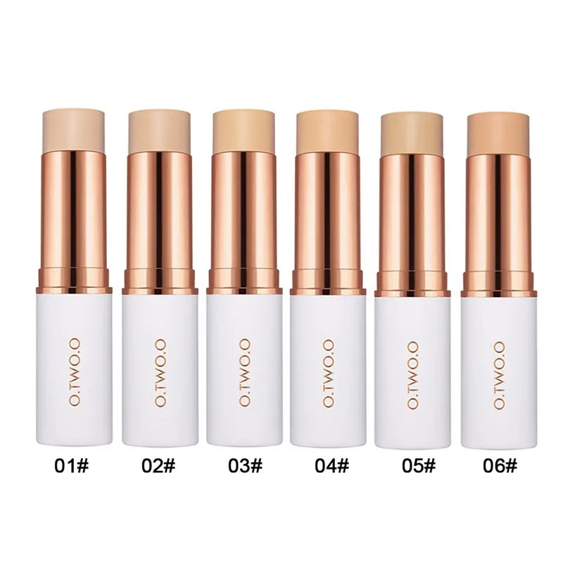 Six different colored concealer sticks arranged in a row