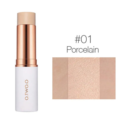 Close-up of a concealer stick being applied to the face