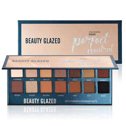 Close-up of eyeshadow palette showing matte and glitter texture