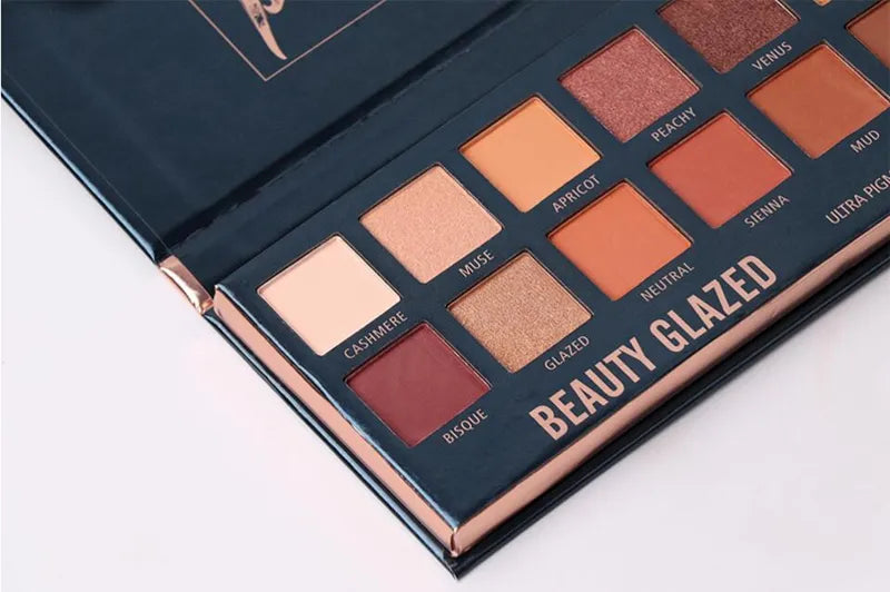 Eyeshadow palette compact with 14 color pans displayed
