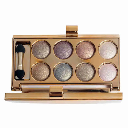 Open warm-toned eyeshadow palette showing eight shimmer shades
