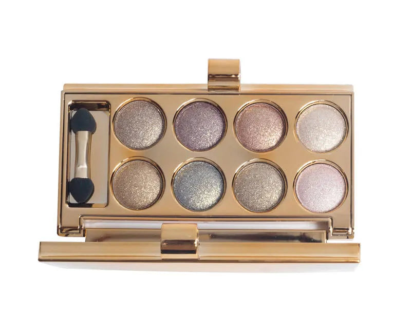 Open warm-toned eyeshadow palette showing eight shimmer shades