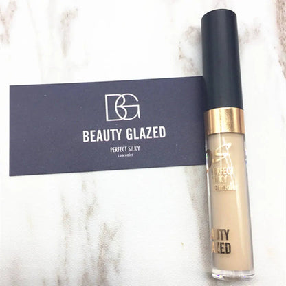 Hand holding concealer palette with two complementary shades visible
