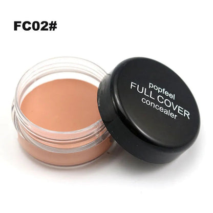 Close-up view of creamy makeup formula being applied to skin with brush