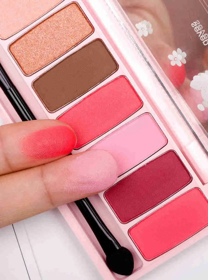 Close-up of red and pink glitter eyeshadow shades in palette