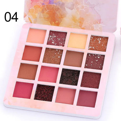 Close-up view of eyeshadow pans with pigmented matte and glitter textures