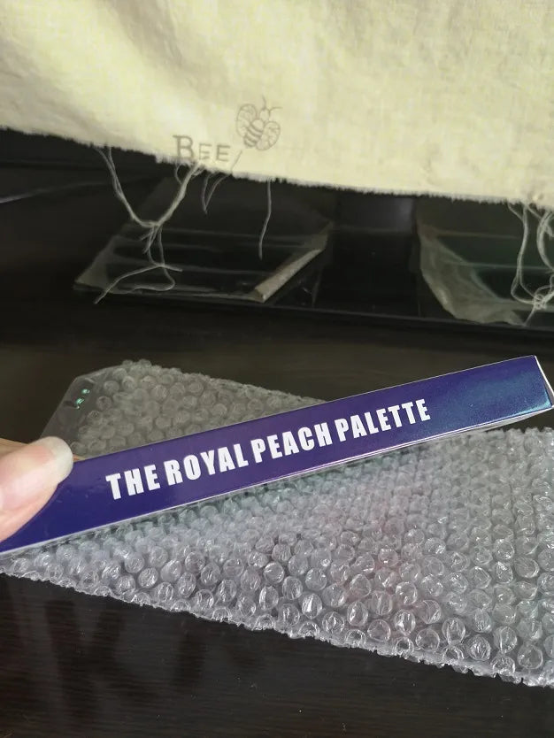 Compact eyeshadow palette with a mirror and applicator included